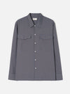 A product shot of the Universal Works Blue/Brown Parker Check Attendant Shirt laid flat against a plain background. The long-sleeve shirt features a blue and brown check pattern, flat collar, button front, and dual chest flap pockets.