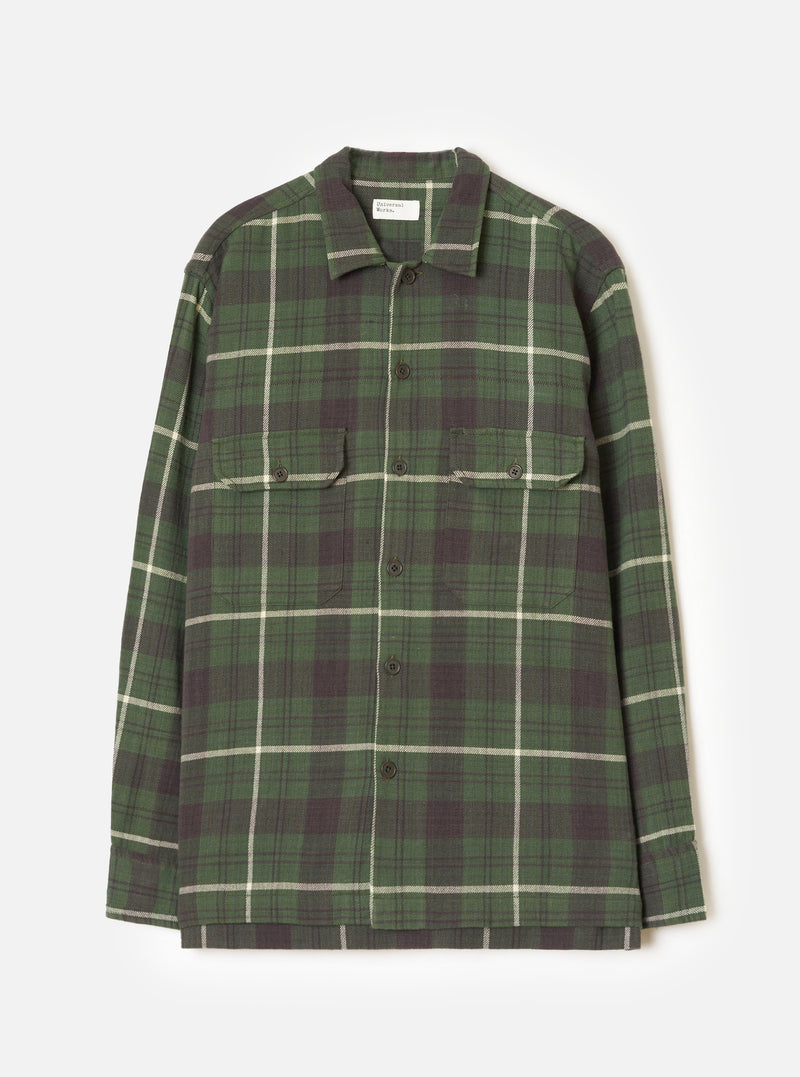 A product image of the Universal Works Olive Washed Check L/S Utility Shirt displayed on a plain background. The shirt features an olive green washed check pattern, flat collar, front button placket, and two buttoned flap chest pockets.