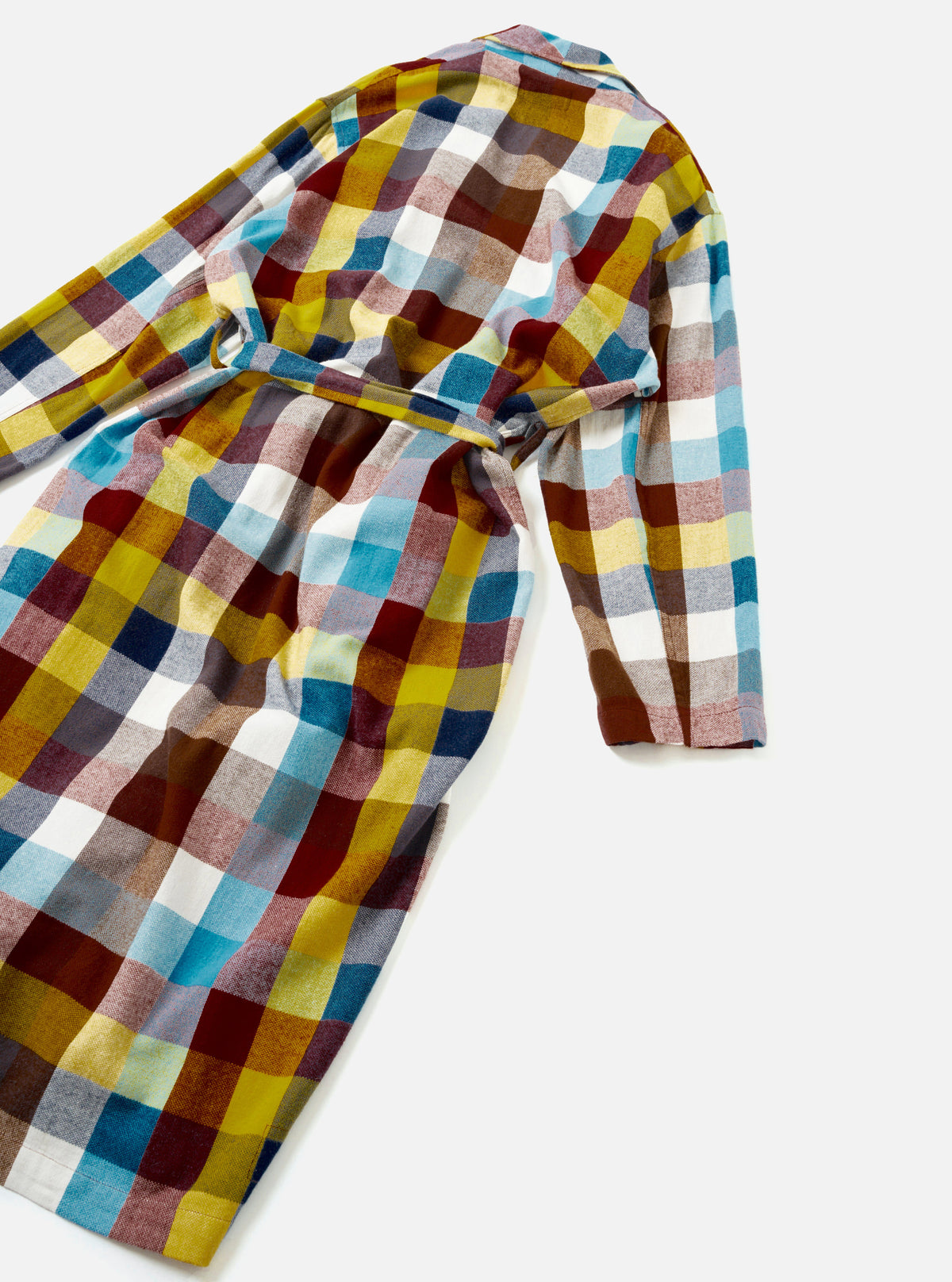 A product shot highlighting the rear view of the Universal Works Multi Check Evans Check Long Dressing Gown laid flat against a plain backdrop, displaying the full-length silhouette, multi-check pattern, and wrapped belt band.