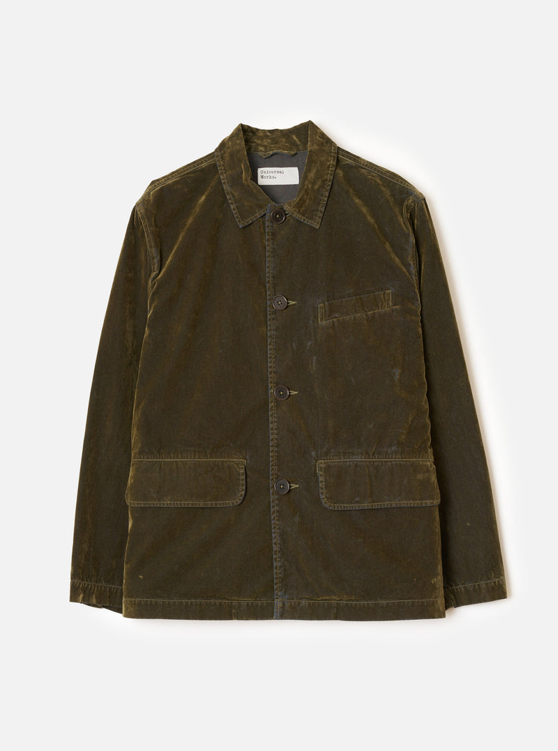 A front studio view of the Olive Flock Chambray Warmus Jacket set against a plain backdrop. The olive green cotton jacket features a button-front closure, classic collar, single chest pocket, and two lower patch pockets.
