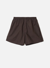Front view of the Universal Works Brown Broadcloth Boxer Shorts shown on a plain backdrop. Features rich brown cotton broadcloth fabric, smooth elastic waistband, side stitching, and classic relaxed fit.