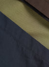 A swatch image showing the multi-colored broadcloth fabric of the Mix Broadcloth Boxer Shorts by Universal Works. Highlights the varied patterned cotton panels set against a plain backdrop.