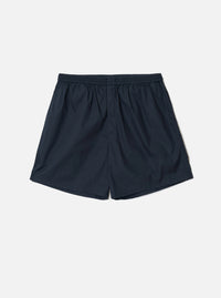 Front view of the Universal Works Navy Broadcloth Boxer Shorts shown on a plain backdrop. Features smooth navy blue cotton broadcloth fabric, comfortable elasticated waistband, and classic undergarment cut.