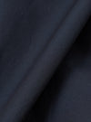 Close-up fabric swatch of the Navy Broadcloth Boxer Shorts by Universal Works. Highlights the tight weave, deep navy shade, and smooth surface of the cotton broadcloth fabric against a plain background.