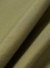A close-up fabric swatch shot showing the texture and weave of the Universal Works Olive Broadcloth Boxer Shorts fabric, detailing the smooth olive green cotton plain-weave material.