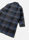 Back view of the Universal Works Navy/Brown Berlin Wool Check Account Coat on a plain backdrop, highlighting the long silhouette, patterned navy and brown wool check weave, and central back hem vent.
