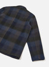 Back view of the Universal Works Navy/Brown Berlin Wool Check OG Bakers Chore Jacket on a plain background, displaying the clean rear panel, two-piece sleeves, and straight hemline in patterned wool check.