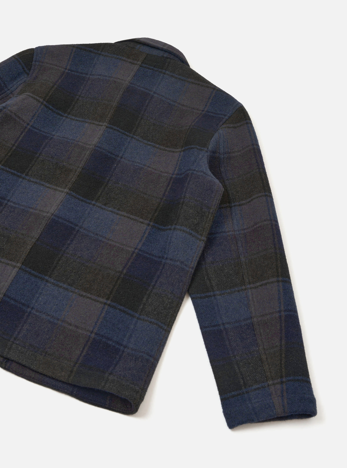 Back view of the Universal Works Navy/Brown Berlin Wool Check OG Bakers Chore Jacket on a plain background, displaying the clean rear panel, two-piece sleeves, and straight hemline in patterned wool check.