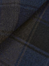 A close-up fabric swatch shot showing the brushed surface and detailed weave pattern of the Universal Works Navy/Brown Berlin Wool Check OG Bakers Chore Jacket in rich navy and brown tones.