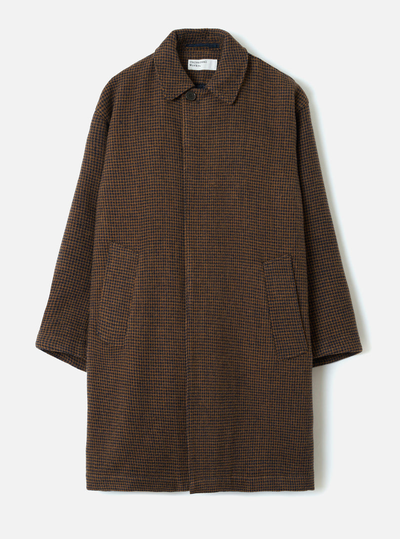 A studio front view of the Navy/Brown Wool Tweed Mix Stan Coat displayed against a plain background. The long coat features a structured collar, full button closure, side slit pockets, and rich dark blue and brown patterned wool tweed.