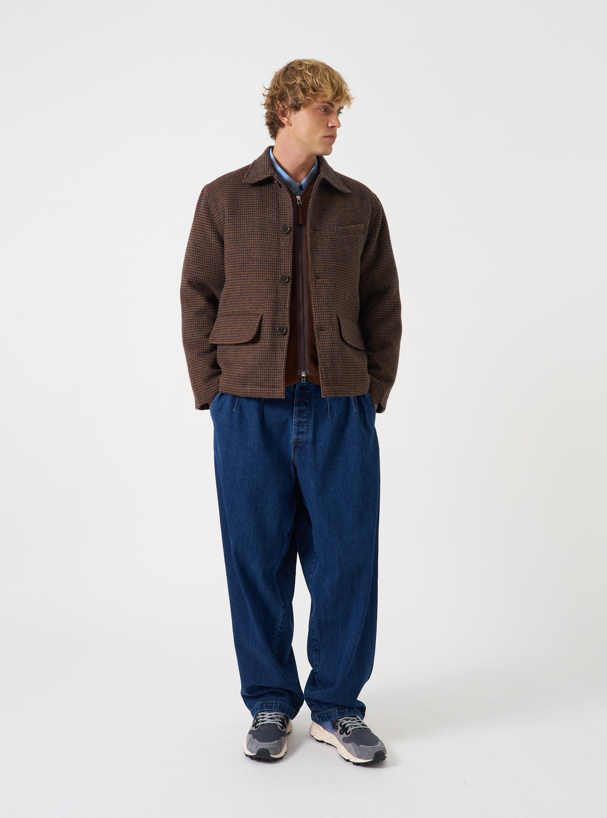 A model wearing the Navy/Brown Wool Tweed Mix Franck Jacket, shown from the front against a plain background. The jacket is styled open over a t-shirt, highlighting the collar, zipper detail, and relaxed fit of the navy brown tweed.