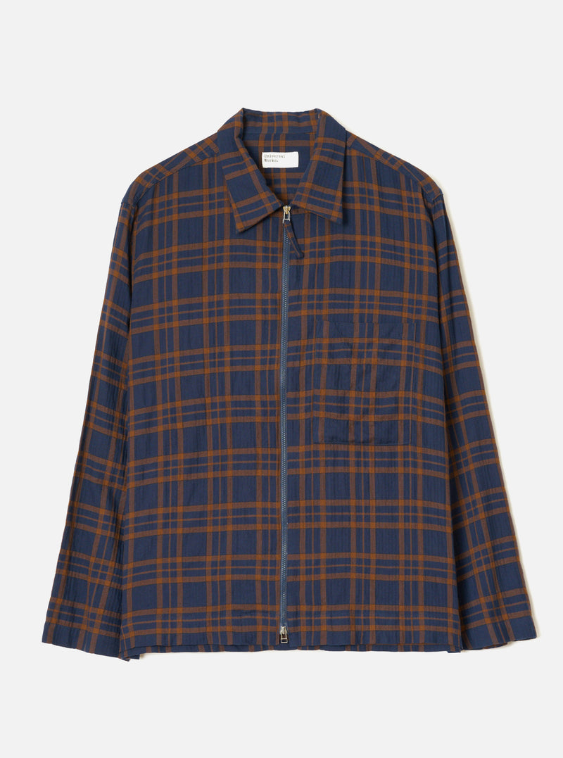 A studio front view of the Navy/Brown Young Check Zip Shirt displayed on a plain background. The overshirt features a classic pointed collar, central front zipper closure, single chest pocket, and a dark navy and brown check pattern.