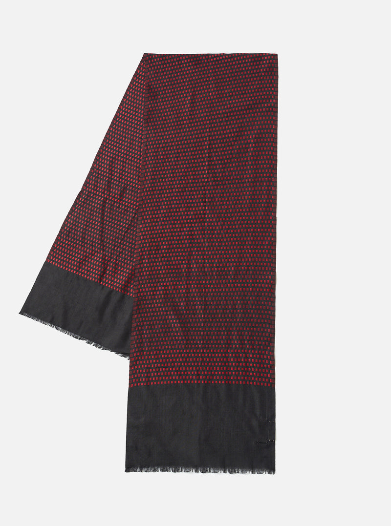 A full view of the Universal Works Black/Red Jacquard Silk Scarf displayed flat against a plain background. The lightweight silk accessory features a woven black and red pattern with clean stitched borders throughout.