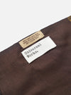 A draped view of the Universal Works Brown/Sky/Gold Jacquard Silk Scarf, displaying its soft handle and light fold lines. The multi-coloured silk scarf is featured prominently against a plain background.