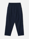 Front product view of the Navy Wool Herringbone Pleated Track Pant against a plain background. The dark navy trousers display a drawstring elasticated waistband, front pleat details, and side pockets.