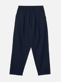 Front product view of the Navy Wool Herringbone Pleated Track Pant against a plain background. The dark navy trousers display a drawstring elasticated waistband, front pleat details, and side pockets.