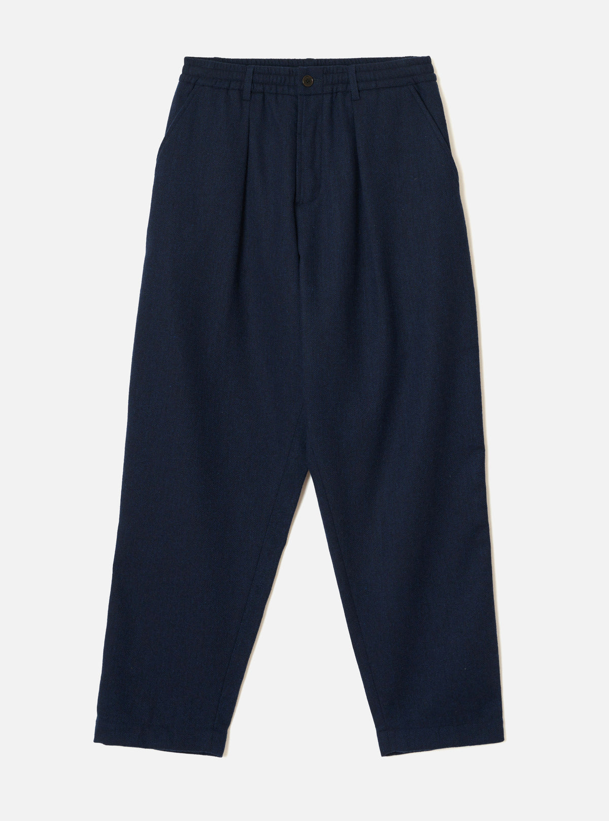 Front product view of the Navy Wool Herringbone Pleated Track Pant against a plain background. The dark navy trousers display a drawstring elasticated waistband, front pleat details, and side pockets.