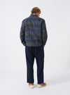 A front view of a model wearing the Olive Shadows Check Franck Jacket. The olive green suiting jacket features a subtle shadow check pattern, tailored lapels, button closure, and front patch pockets set against a plain background.