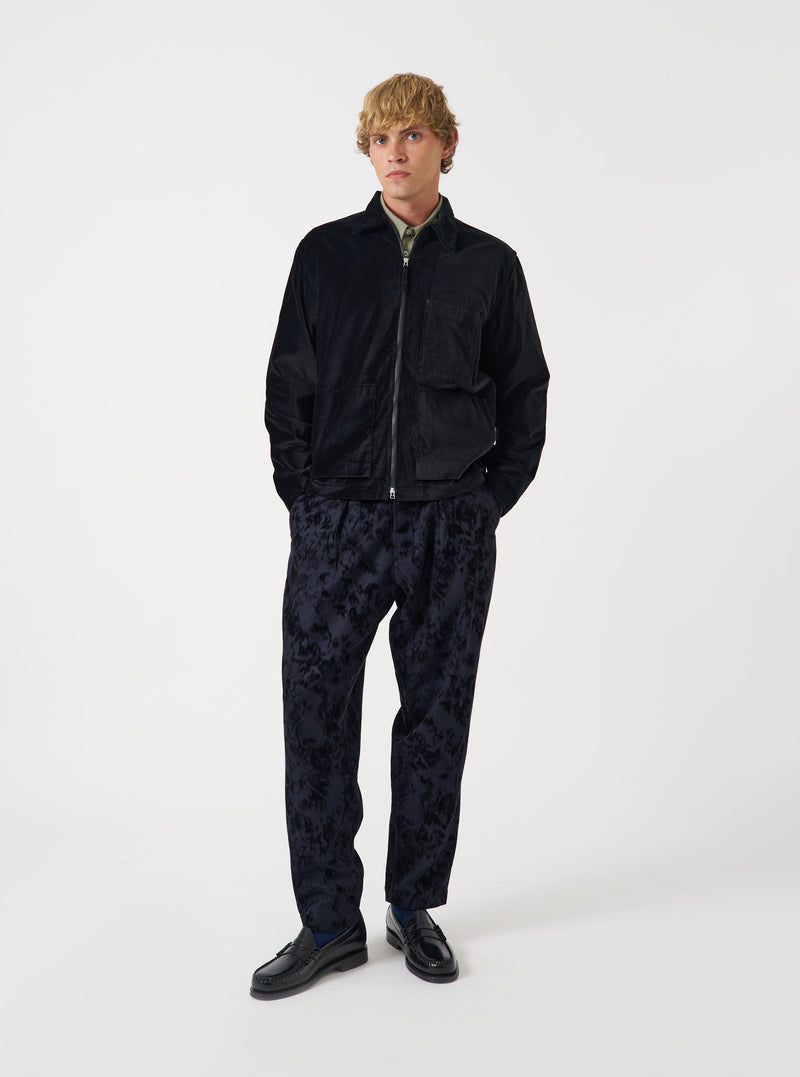A front view of a model wearing the Black CPH Velvet Zip OS Shirt. The black cotton velvet overshirt features a full zip front closure, classic collar, relaxed fit, and soft velvet texture set against a plain neutral background.