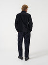 A back view of a model wearing the Black CPH Velvet Zip OS Shirt. The image shows the rear construction of the black velvet overshirt, displaying the relaxed shoulders, smooth texture, and straight hemline against a plain backdrop.