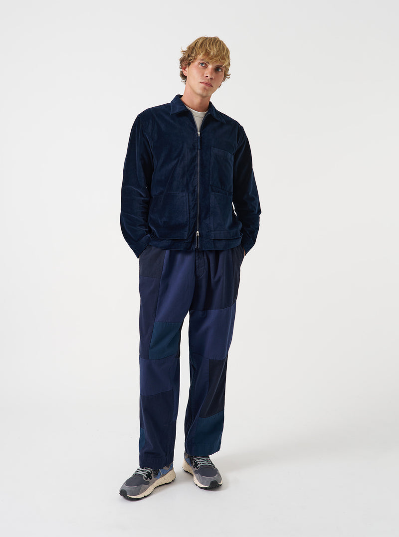 A front view of a model wearing the Navy CPH Velvet Zip OS Shirt. The navy blue cotton velvet overshirt displays a central zip fastening, classic pointed collar, and relaxed silhouette set against a plain neutral backdrop.