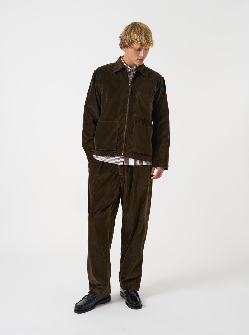 A front view of a model wearing the Olive CPH Velvet Zip OS Shirt. The olive green velvet overshirt features a front metal zip fastening, neat collar, long sleeves, and soft textured finish against a plain neutral backdrop.