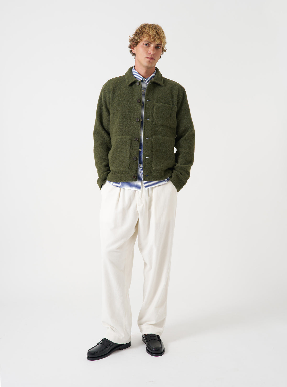 A front view of a model wearing the Ecru CPH Velvet Oxford Pant. The light off-white velvet trousers feature a loose wide-leg fit, pleated front detailing, and drawstring waist shown against a plain neutral studio backdrop.