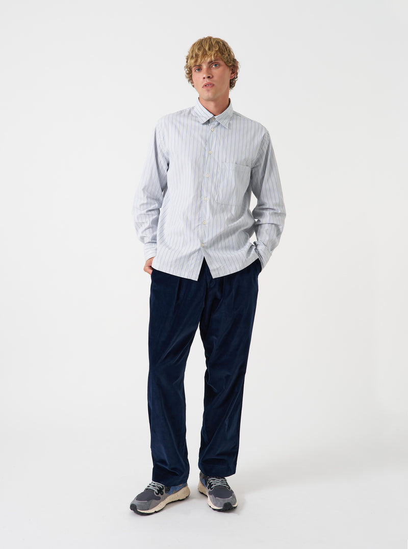 A front view of a model wearing the Navy CPH Velvet Oxford Pant. The navy blue cotton velvet trousers display a wide loose fit, pleated front, and adjustable drawstring waist set against a plain neutral backdrop.