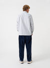 A back view of a model wearing the Navy CPH Velvet Oxford Pant. The photograph captures the rear fit of the navy velvet trousers, emphasizing the wide cut leg, subtle sheen of the fabric, and hem detail against a plain background.
