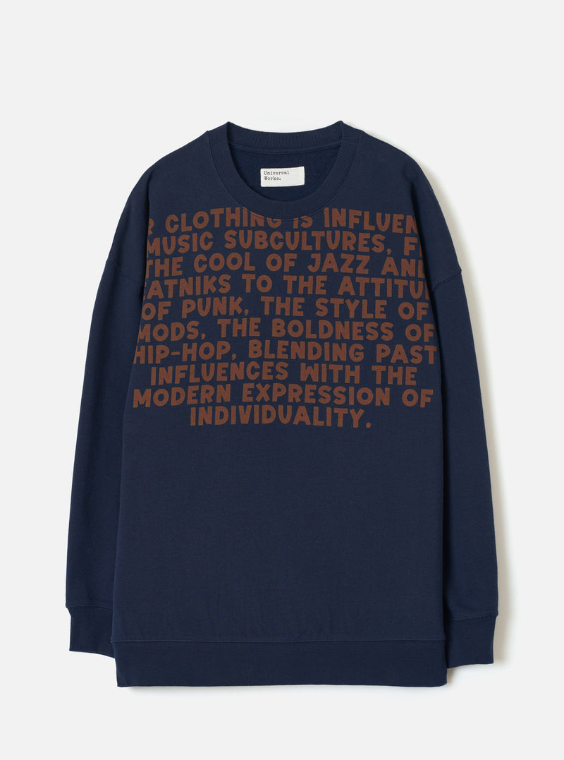 A product shot of the Universal Works Navy Brushback Sweat Cool Of Jazz Loose Sweatshirt displayed flat against a plain background. The navy cotton sweatshirt features a loose fit, ribbed crew collar, long sleeves, and front print.