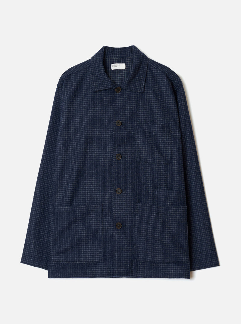 The Navy Check Bobby Wool Mix Bakers Overshirt is laid flat on a light grey studio backdrop. It features a fine grid check pattern, camp collar, five dark horn-effect front buttons, one chest patch pocket, and two large lower patch pockets.