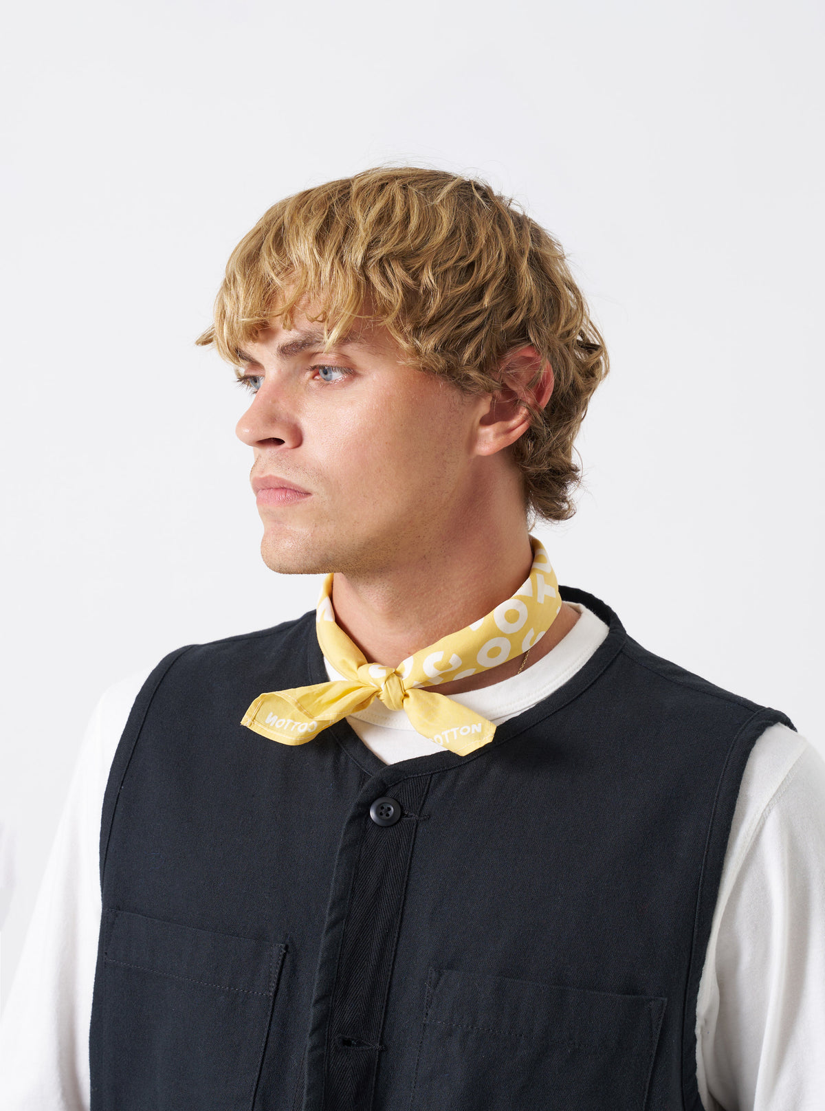 A group arrangement of cotton neckerchiefs featuring the Mustard Jazz/Beatniks Print Neckerchief set on a plain background, displaying the graphic jazz text print and vibrant hue.