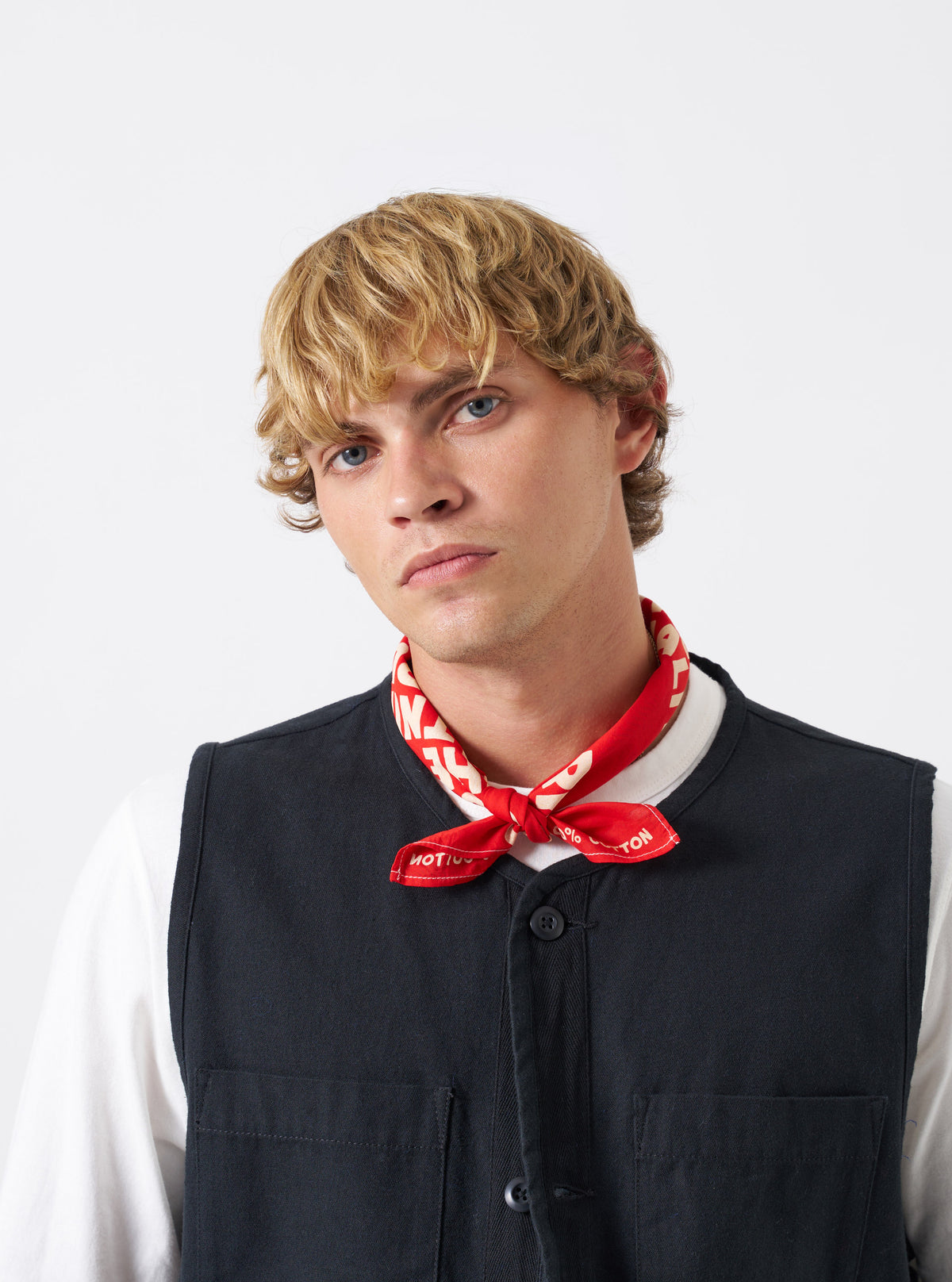 A group shot of printed neckerchiefs showcasing the Red Jazz/Beatniks Print Neckerchief on a clean backdrop, highlighting its eye-catching bold red color and graphic text print.