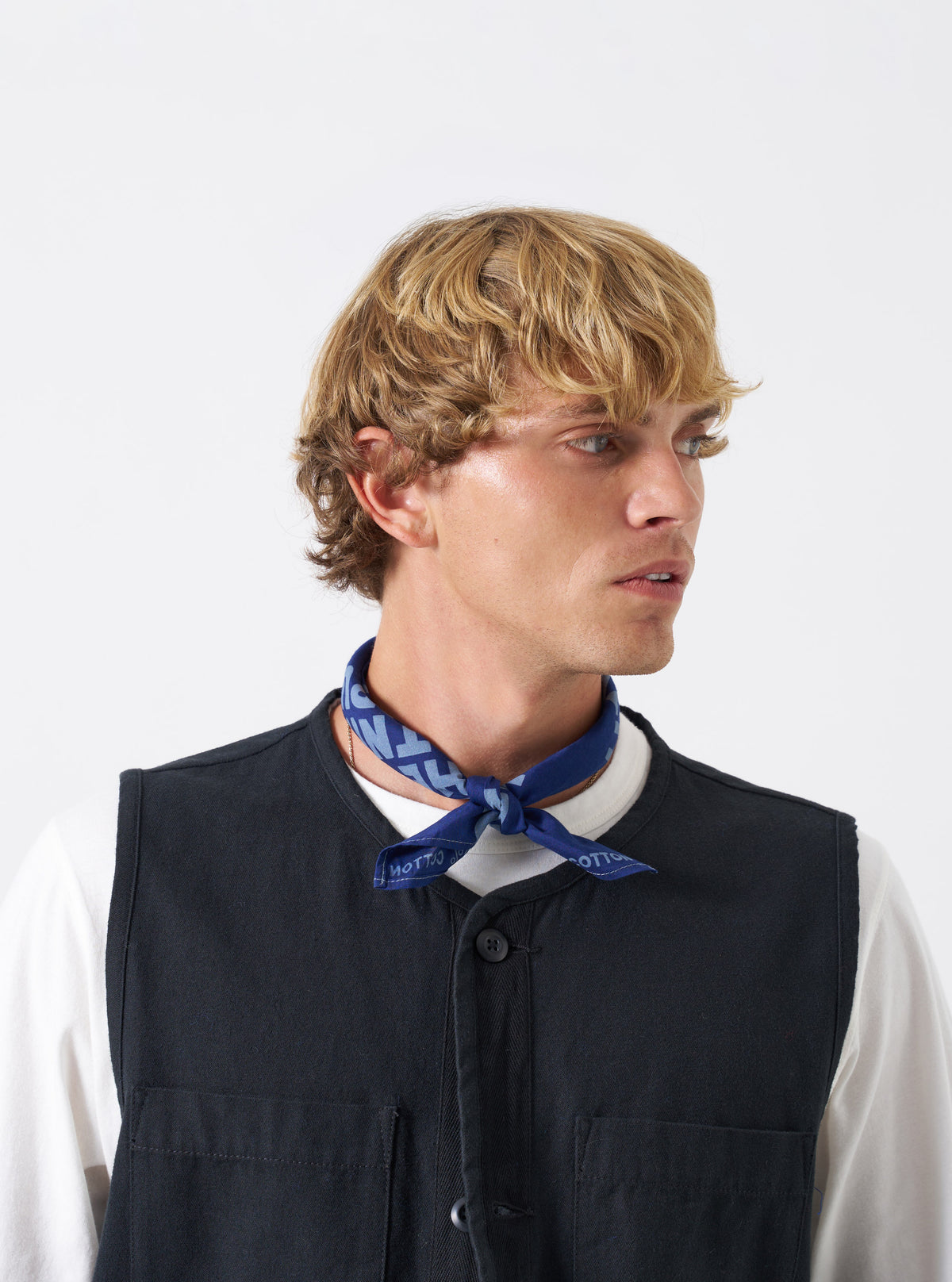 A styled group view featuring the Blue Jazz/Beatniks Print Neckerchief among other colorways against a neutral background, showing its distinct blue color and graphic beatnik print.