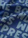 A close-up fabric swatch image of the Blue Jazz/Beatniks Print Neckerchief on a plain background, highlighting the intricate jazz-inspired graphic text print and lightweight cotton weave detail.