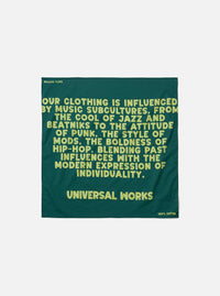 A square Forest Green Jazz/Beatniks Print Neckerchief laid flat against a neutral backdrop. Made from lightweight cotton, the neckerchief displays a prominent jazz-themed graphic text pattern.