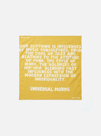 A square Mustard Jazz/Beatniks Print Neckerchief laid out flat against a plain studio background. Made from cotton, it features a distinctive jazz-inspired graphic print throughout.