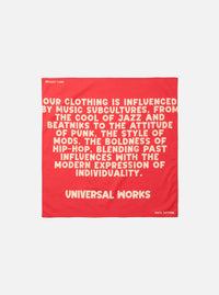 A square Red Jazz/Beatniks Print Neckerchief displayed flat against a clean studio background. The cotton neckerchief features a striking red tone and bold graphic text print detail.