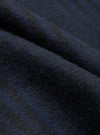 Close-up fabric detail shot of the navy wool mix oxford pant. The brushed, lightly felted textile shows a dense, softly napped surface with fine individual fibres visible throughout. Deep navy tones shift subtly across the folded cloth, revealing slight blue and charcoal variation in the weave.