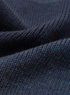 A close-up fabric swatch view of the Navy British Wool Scarf against a light background, highlighting the intricate texture, tight weave pattern, and rich dark navy shade of the British wool yarn.