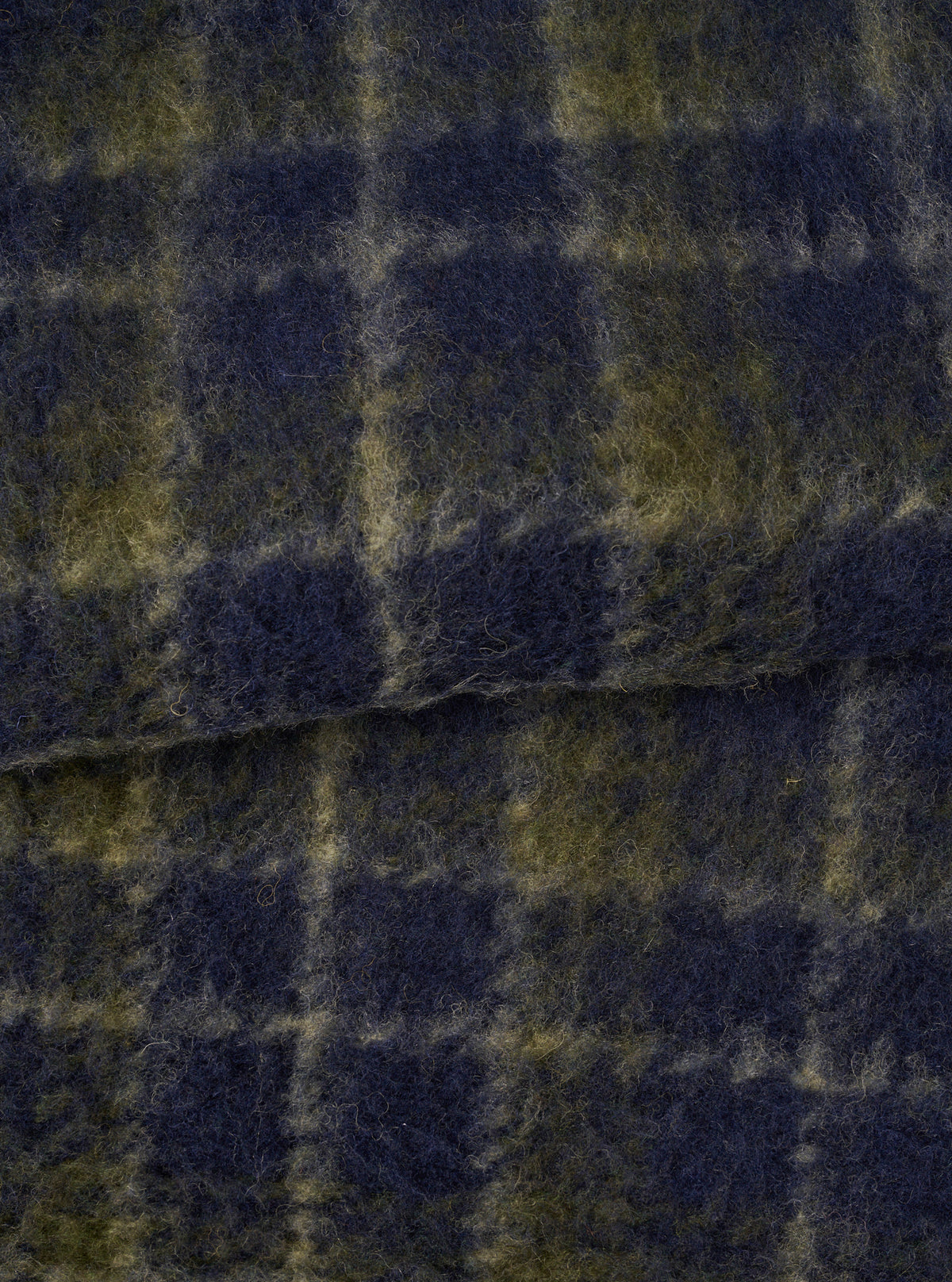 A close-up fabric swatch image of the Navy/Olive Check Daffy Fleece Mix Cardigan on a plain background, highlighting the soft brushed texture, navy and olive check pattern, and wool-blend weave.