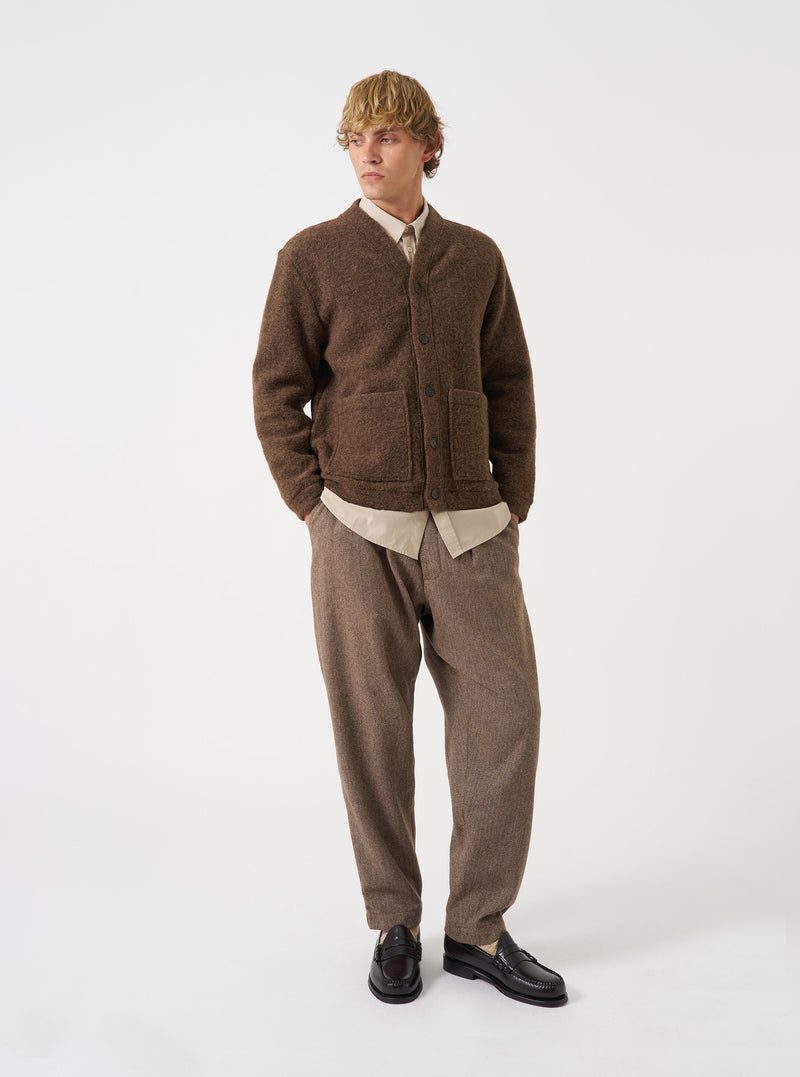 A model wearing the Brown Marl Wool Fleece Advance Cardigan against a plain studio backdrop. The cardigan is styled buttoned up, showcasing its relaxed boxy fit, V-neck collar, and front patch pockets.