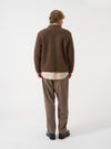 A model wearing the Brown Marl Wool Fleece Advance Cardigan against a plain studio background, shown from an alternate angle to highlight the loose fit, comfortable drape, and soft wool fleece finish.