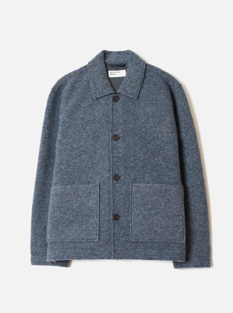 The Slate Blue Wool Fleece Rams Jacket laid flat against a plain studio background. The boxy jacket features a neat point collar, button-down placket, drop shoulders, and two lower front patch pockets.