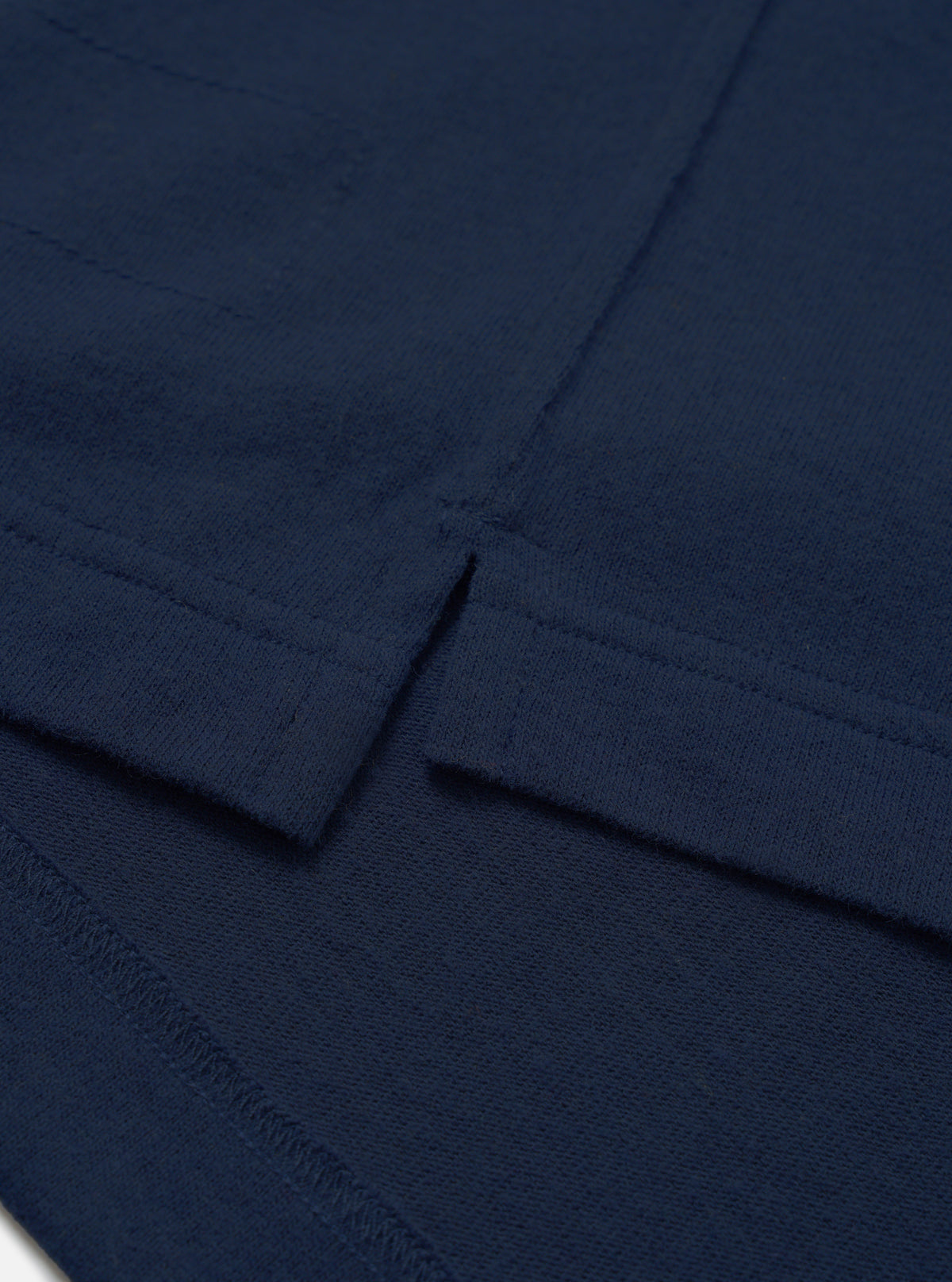 Detail view of the Dark Navy Recycled Wool Mix SJ Pullover L/S Shirt on a plain background, highlighting the four-button placket, classic shirt collar, chest patch pocket, and soft jersey knit texture.