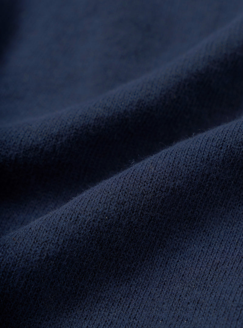 Close-up fabric swatch image of the Dark Navy Recycled Wool Mix SJ Pullover L/S Shirt, showcasing the fine single jersey knit texture and dark navy heathered wool mix material on a light background.