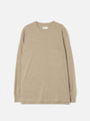 Dark sand marl long-sleeve pocket tee in recycled wool mix jersey, laid flat on a white studio backdrop. Features a crew neck, single patch chest pocket, ribbed cuffs, and a straight hem. A Universal Works woven label sits at the inside neckline.