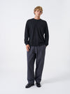 A model wearing the Black Recycled Wool Mix SJ L/S Pocket Tee against a plain studio background. The long-sleeve t-shirt features a casual crew neckline, patch chest pocket, and relaxed boxy fit.