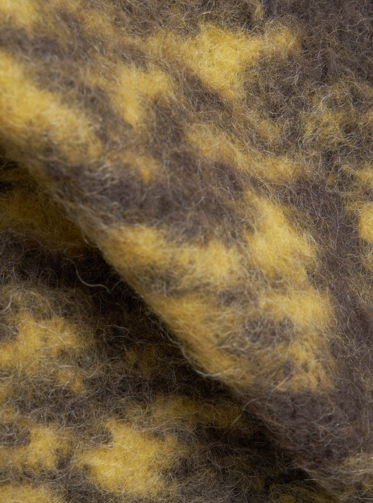 A square fabric swatch image of the Brown Dolce Fleece Cardigan against a solid plain background, emphasizing the rich brown color tone, soft brushed texture, and premium blend structure of the fleece fabric.