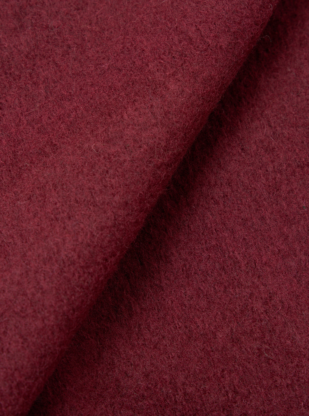 A close-up fabric swatch image of the Berry/Brown Wool Fleece Cardigan against a plain light background, revealing the intricate flecked texture, rich berry-brown wool blend weave, and soft knit feel.